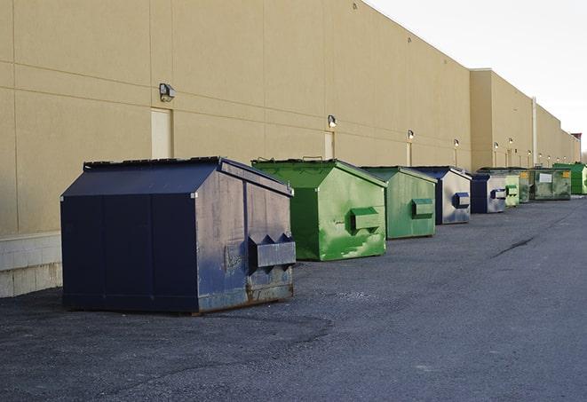 a group of construction workers taking a break near a dumpster in Buffalo